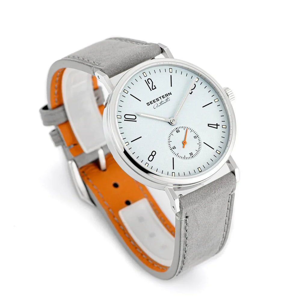 SEESTERN automatic watch with white dial, black numerals, orange seconds hand, and grey leather strap