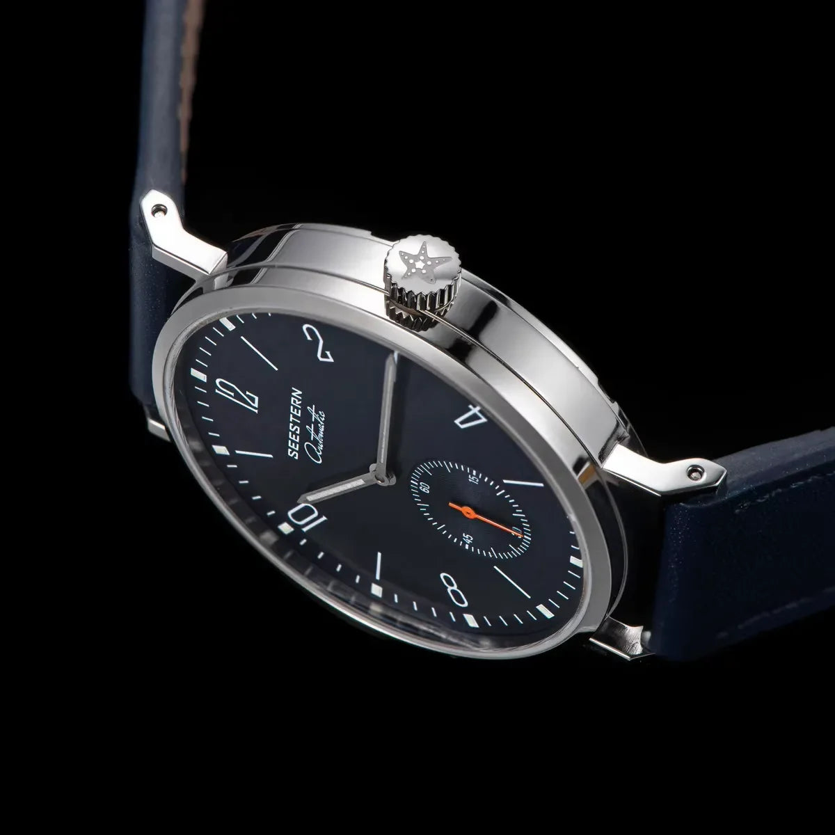 Close-up of Seestern automatic watch with navy blue dial and leather strap on black background