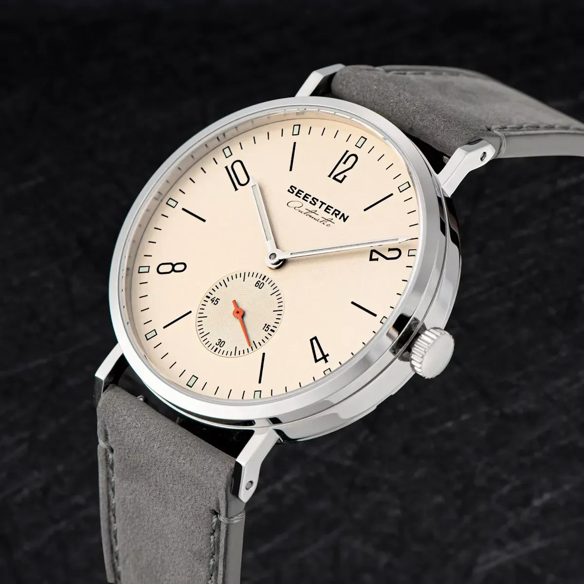 Close-up of Seestern automatic wristwatch with beige dial, gray leather strap, and small seconds subdial